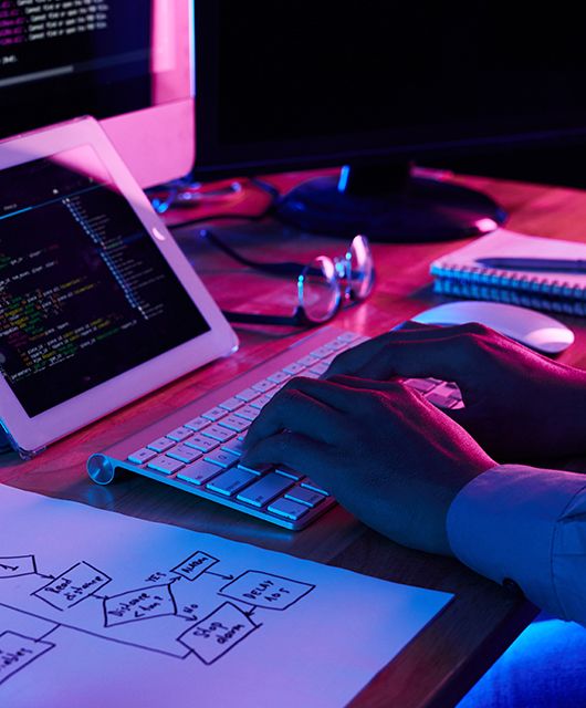 Close-up image of programmer working at his desk in office